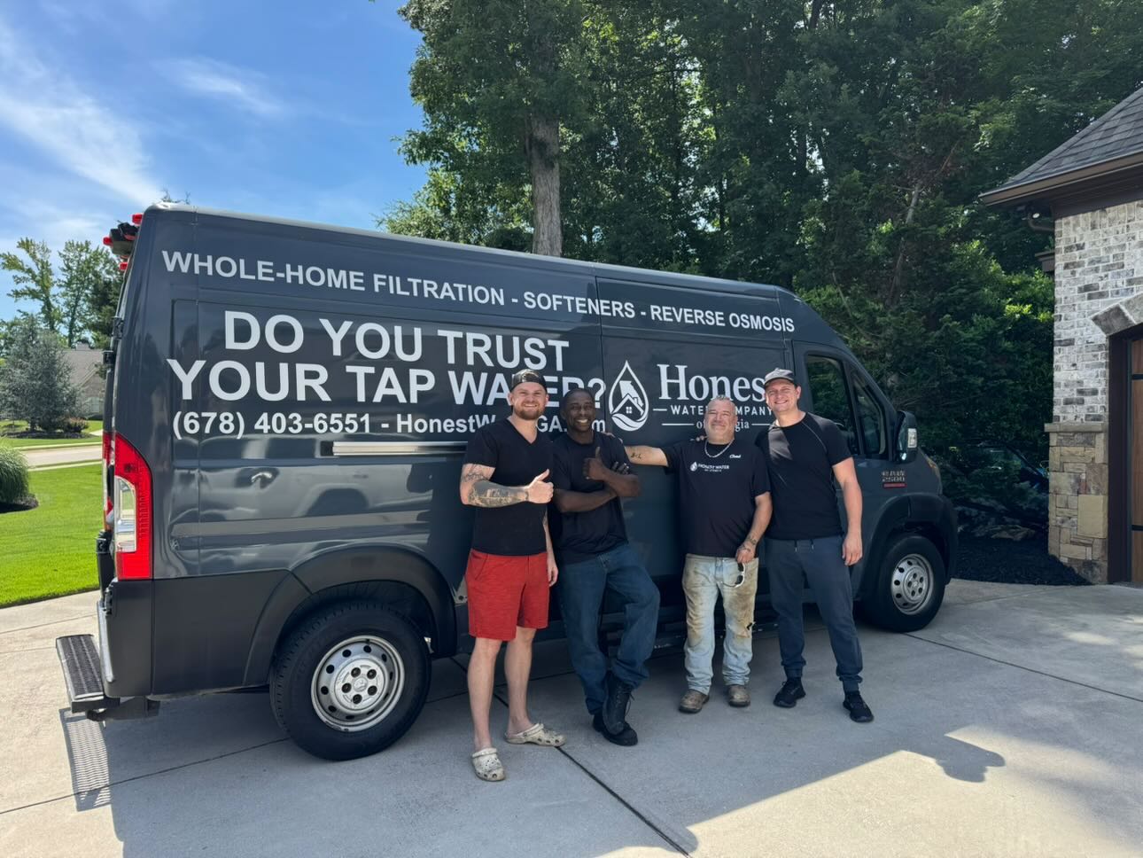 The Honest Water of Georgia crew standing in front of their company van after a whole-home water filtration install